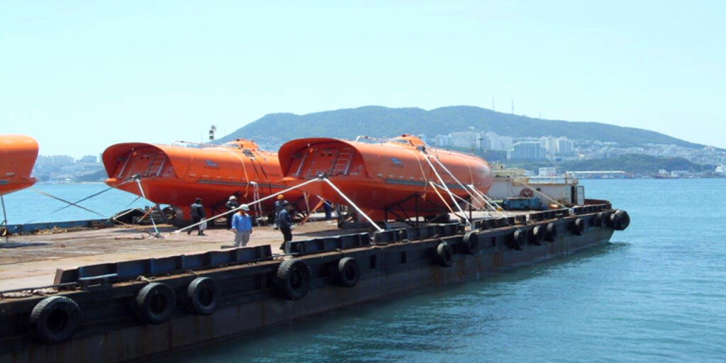 Loaded Life Boat from Container vessel to Flat Barge